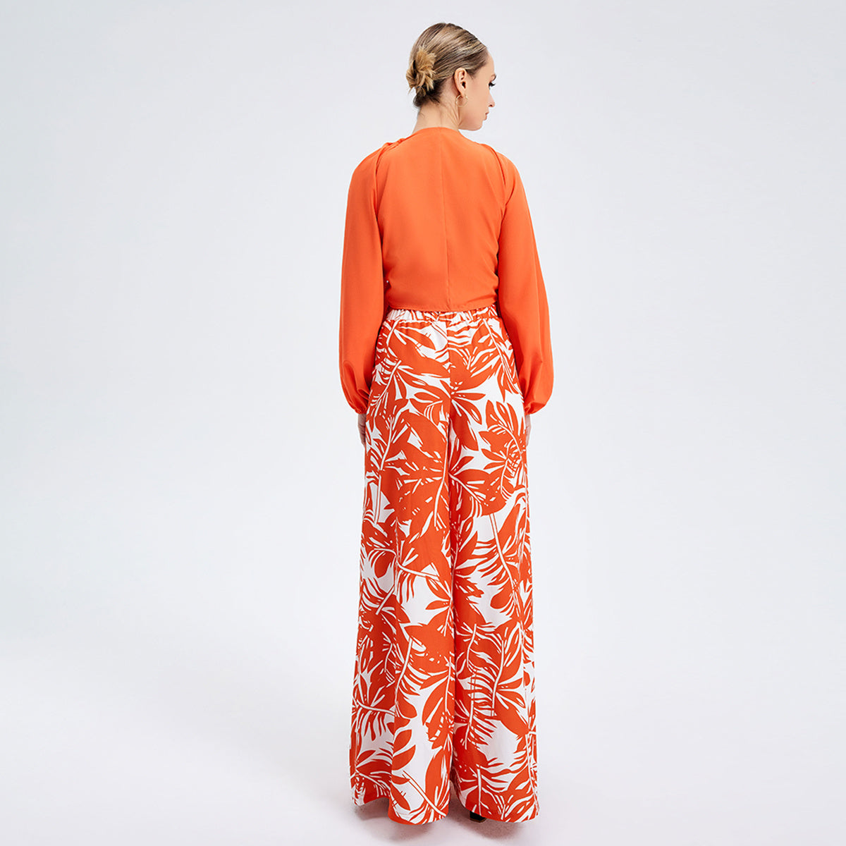 a woman in a long orange and white skirt