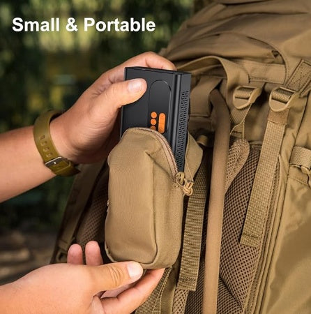 a person putting a device in a backpack