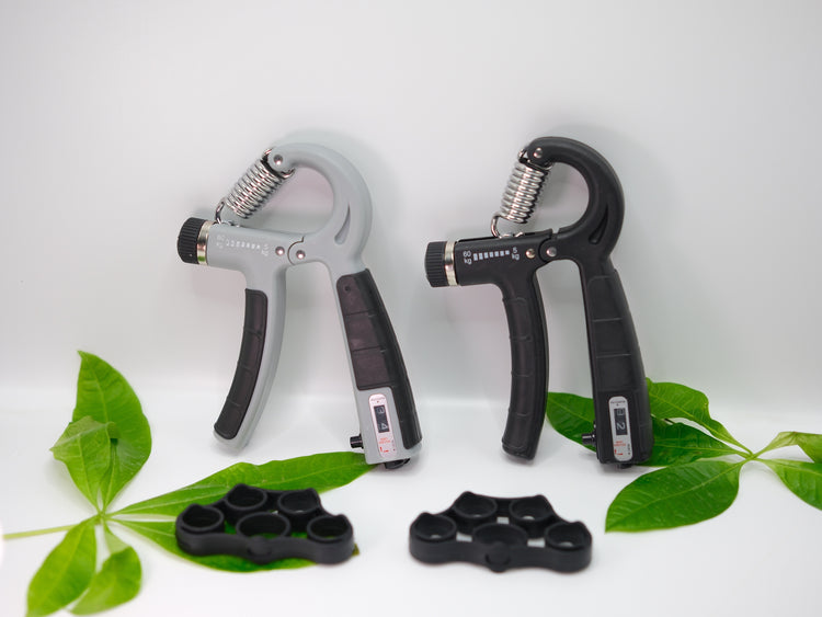 a pair of hand grippers next to green leaves