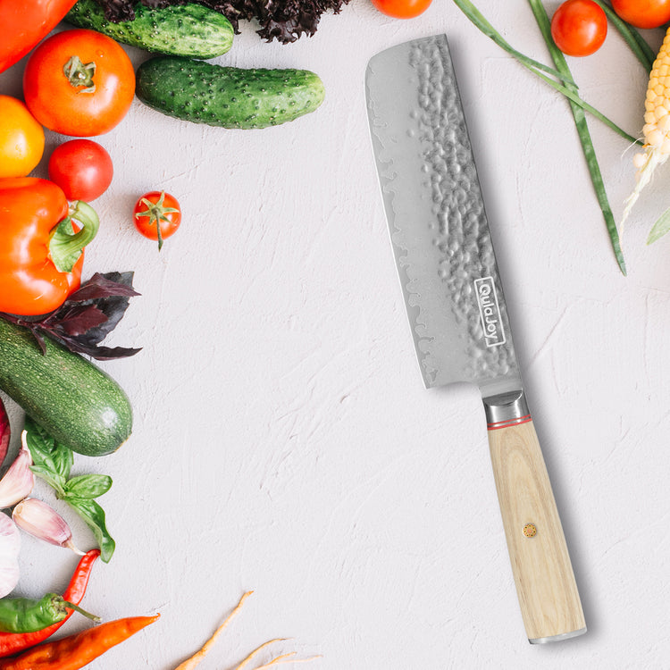 a knife next to vegetables