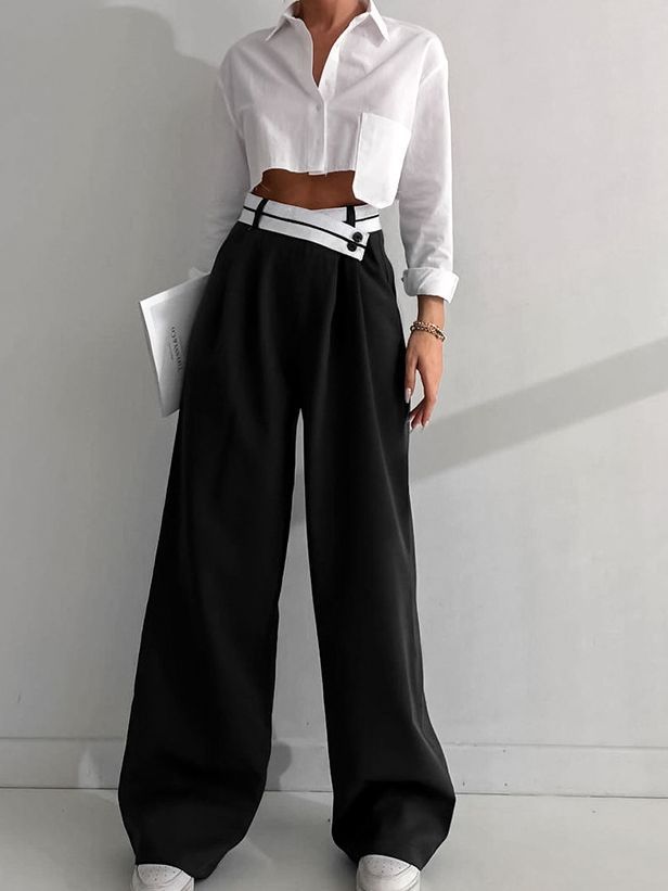 a woman in a white shirt and black pants