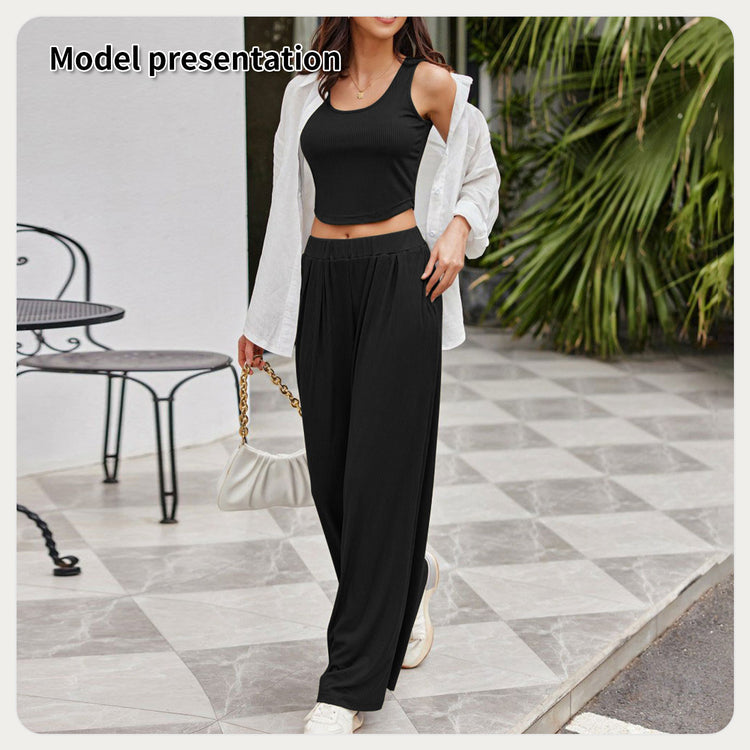 a woman wearing a black top and pants