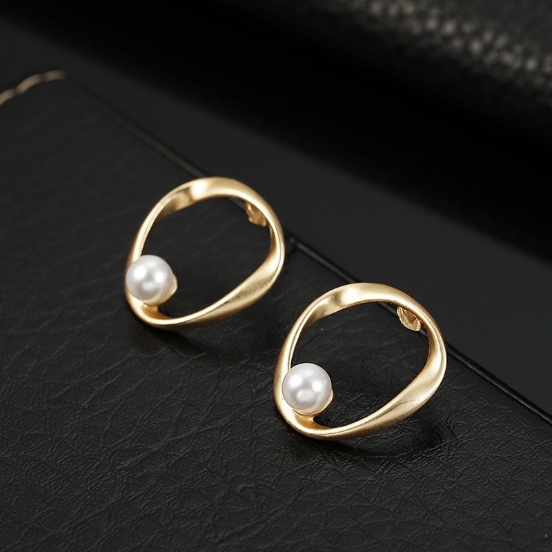 a pair of gold earrings with pearls