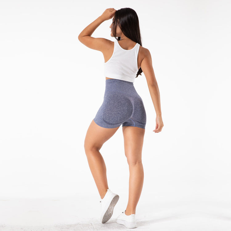 a woman in shorts and a tank top