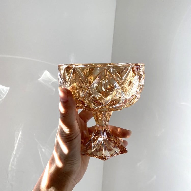 a hand holding a glass