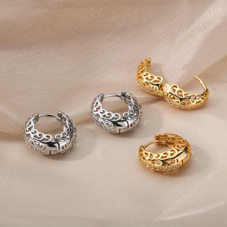 a group of earrings on a fabric