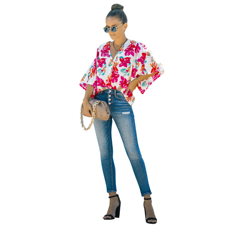 a woman wearing sunglasses and a floral shirt