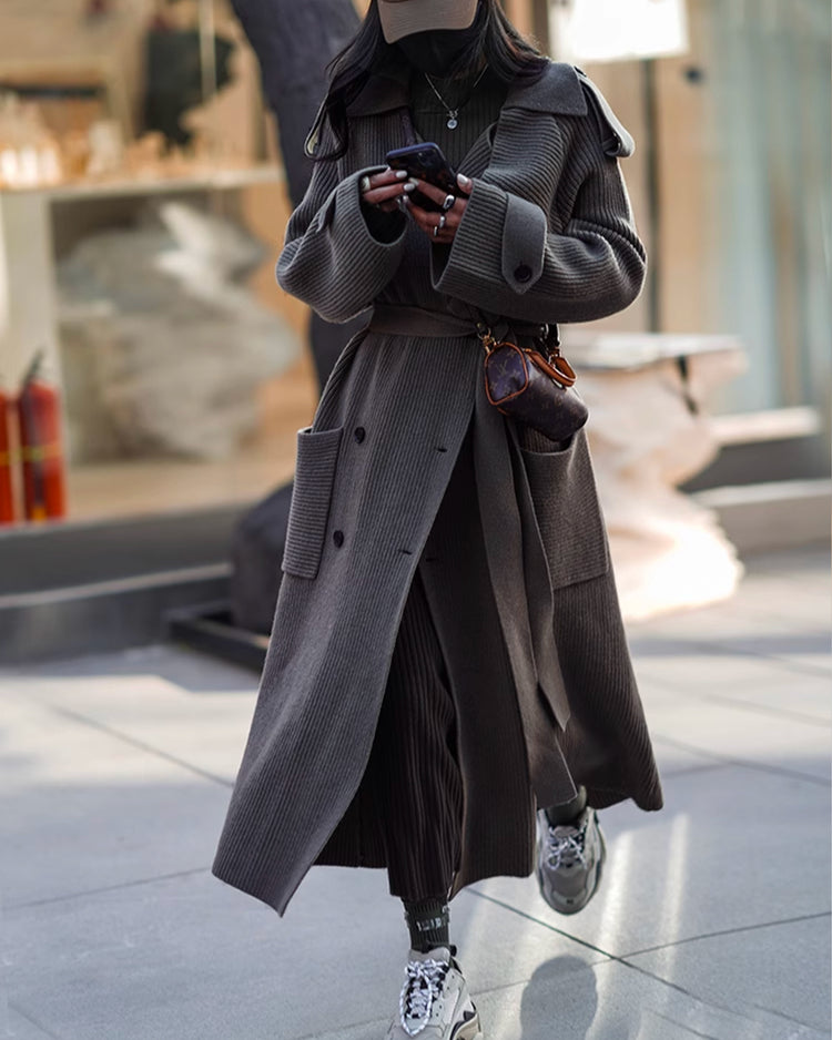 a woman in a long coat