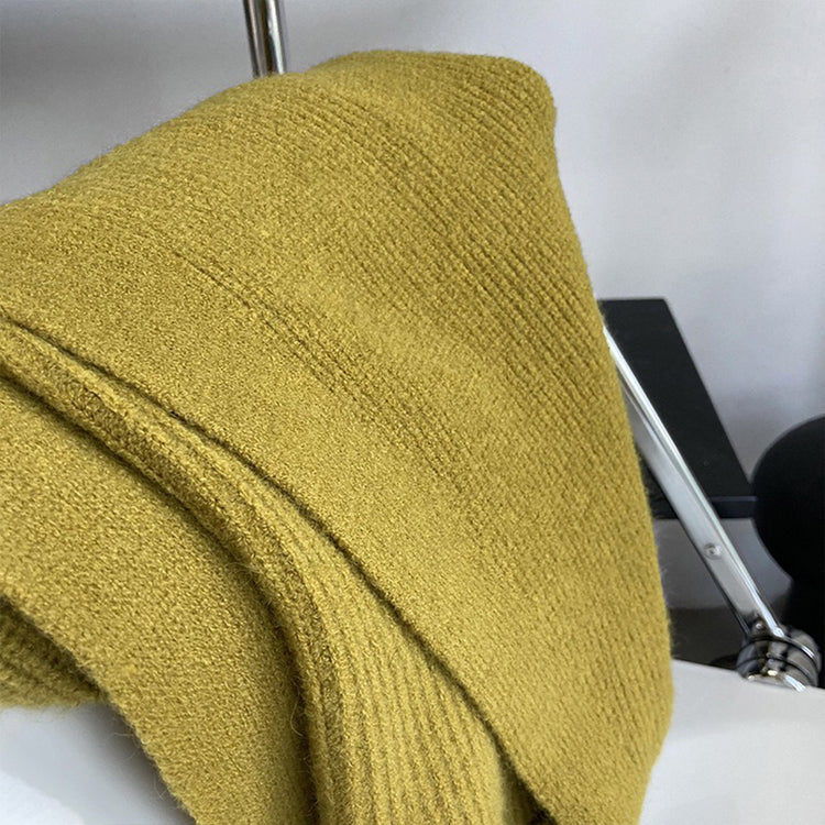 a yellow knitted fabric on a metal rack