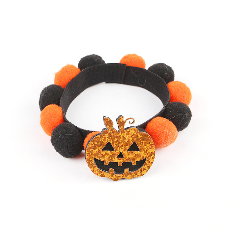 a headband with a pumpkin and a small orange and black object