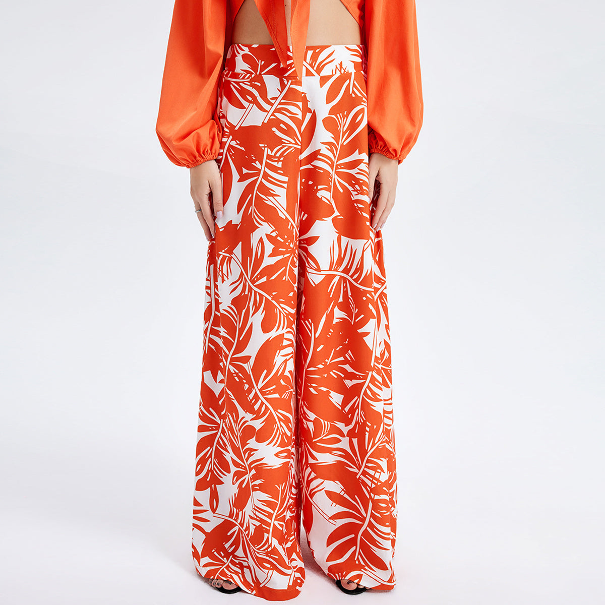 a woman wearing a long orange and white dress