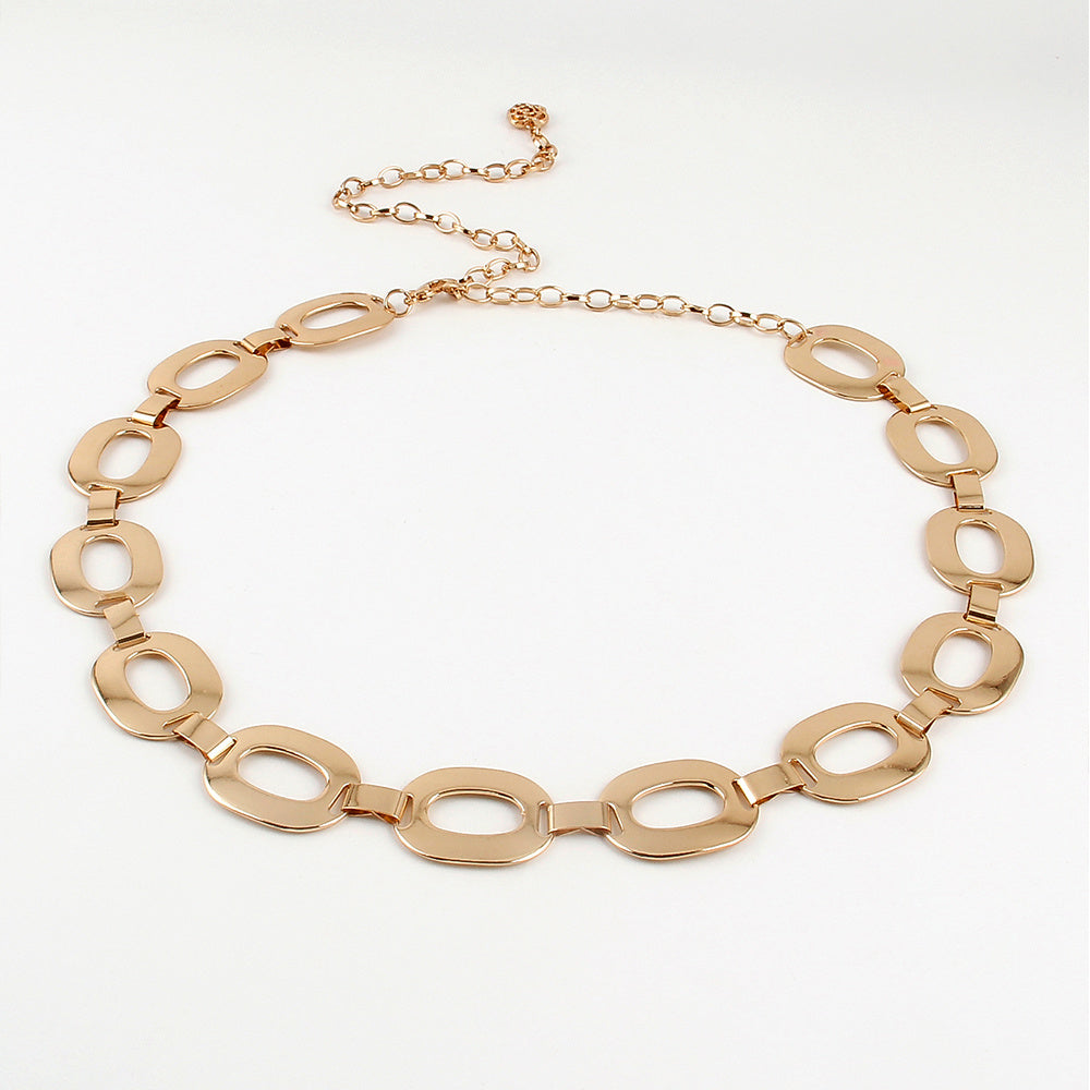 a gold necklace on a white background