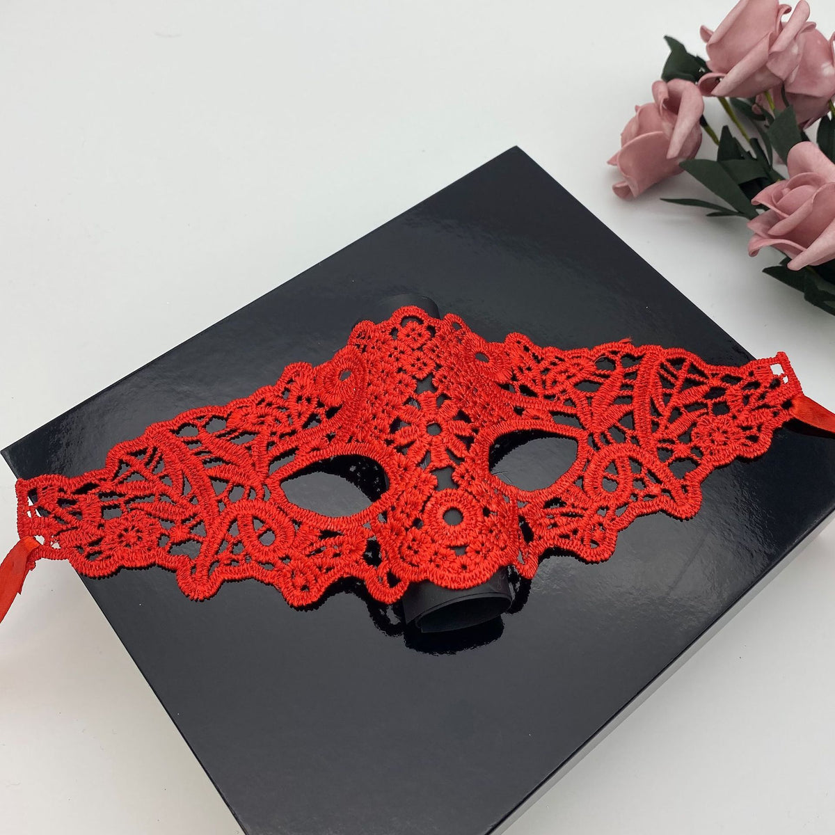 a red mask on a black box