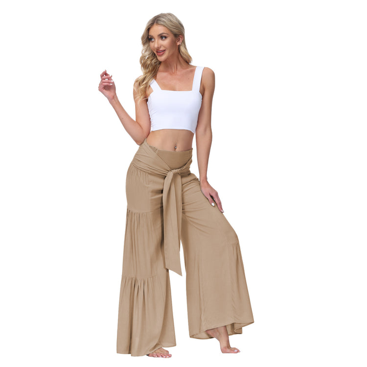 a woman in a white top and tan pants