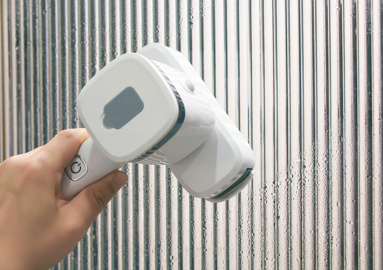 a hand holding a white device