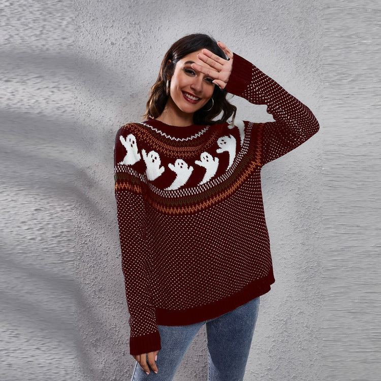 a woman wearing a red sweater with white ghosts on it