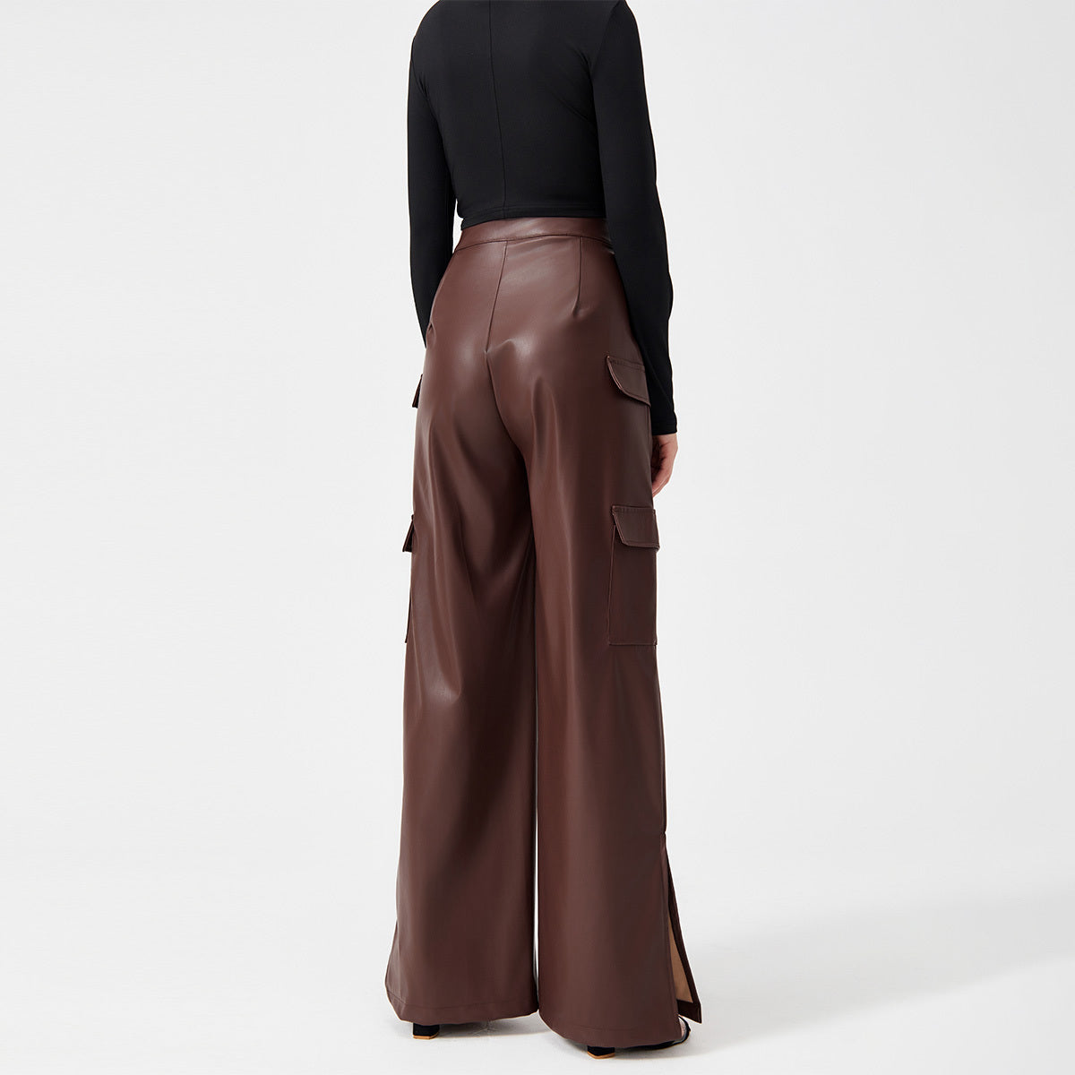 a woman in a black shirt and brown pants