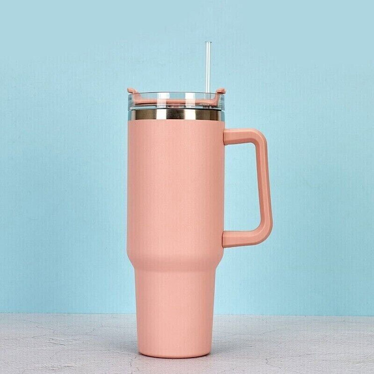 a pink mug with a straw