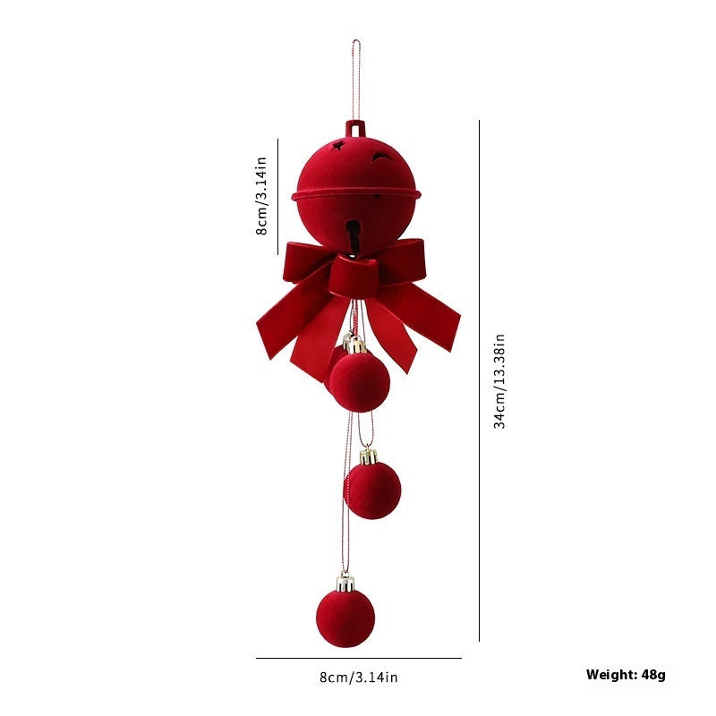 a red bell with a bow and ribbon