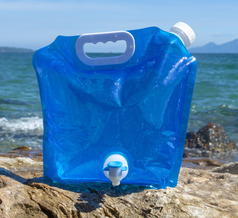 a blue water jug on a rock by the water