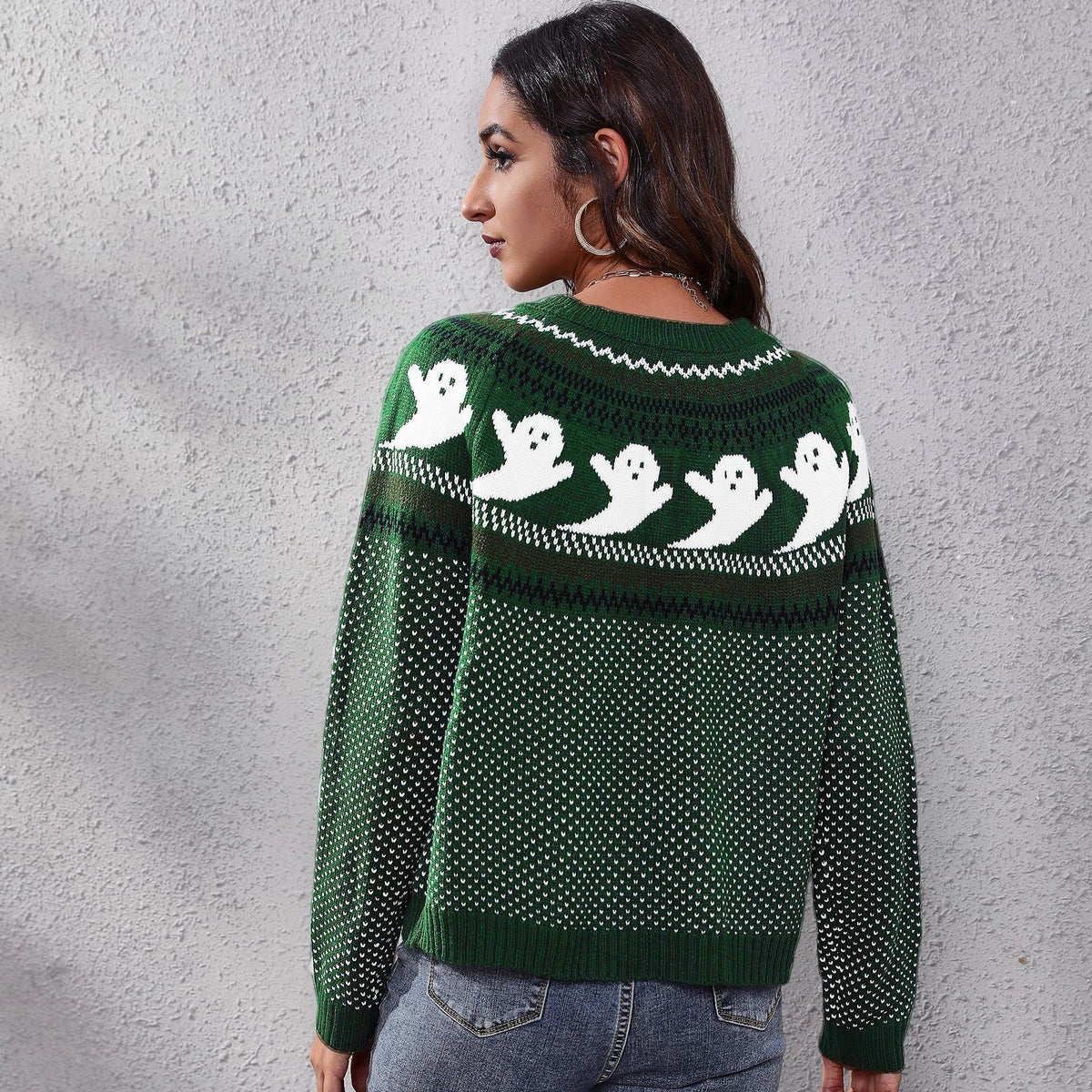 a woman wearing a green and white sweater