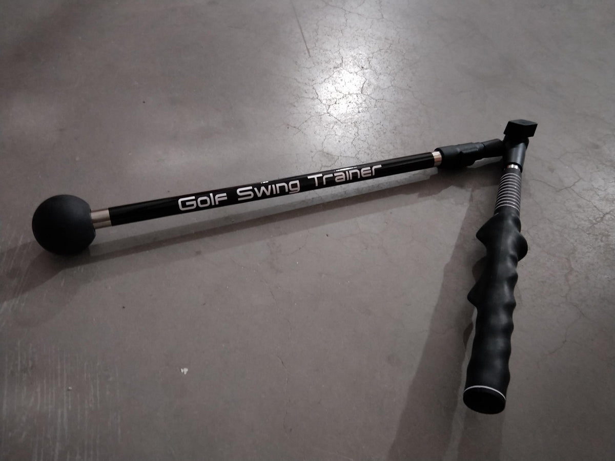 a pair of golf clubs on a grey surface