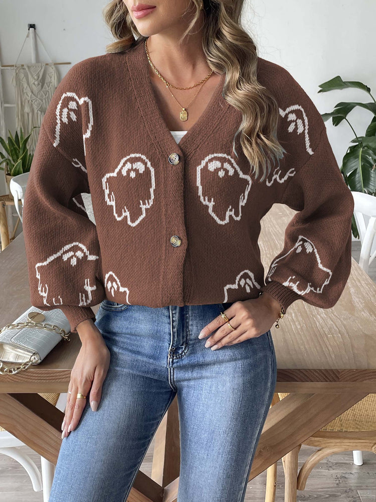 a woman wearing a brown sweater with white ghosts on it