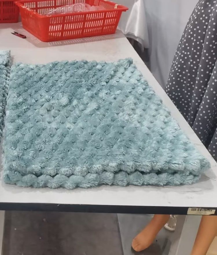 a blue fluffy rug on a table