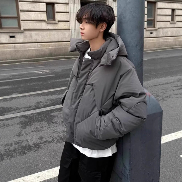 a man leaning against a pole