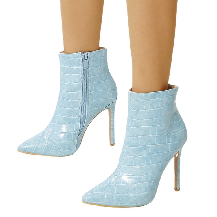 a pair of legs wearing blue boots