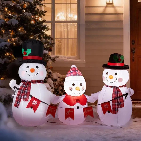 a group of snowmen in front of a house