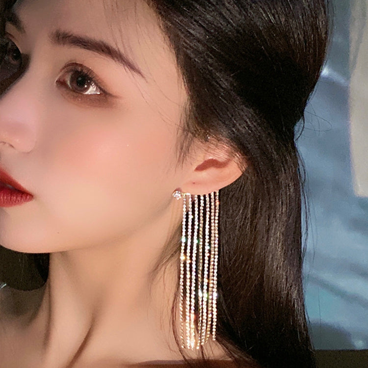 a woman with long hair wearing earrings