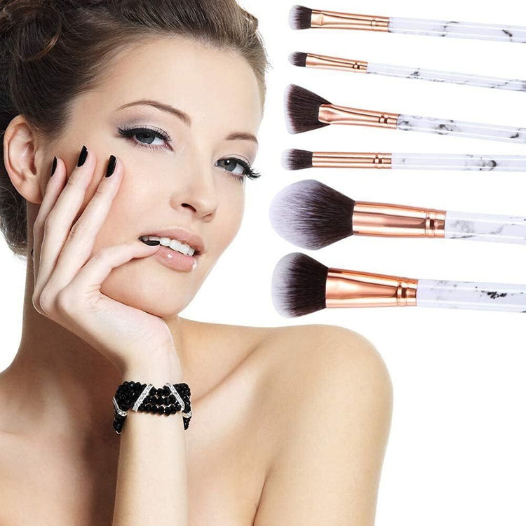 a woman with makeup brushes