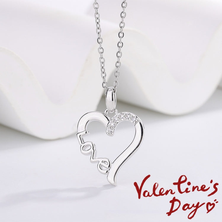 a silver heart necklace with a diamond pendant