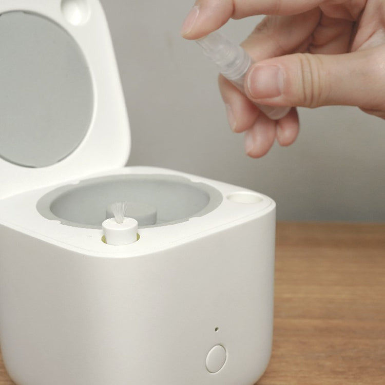 a person spraying a toothpaste into a white container