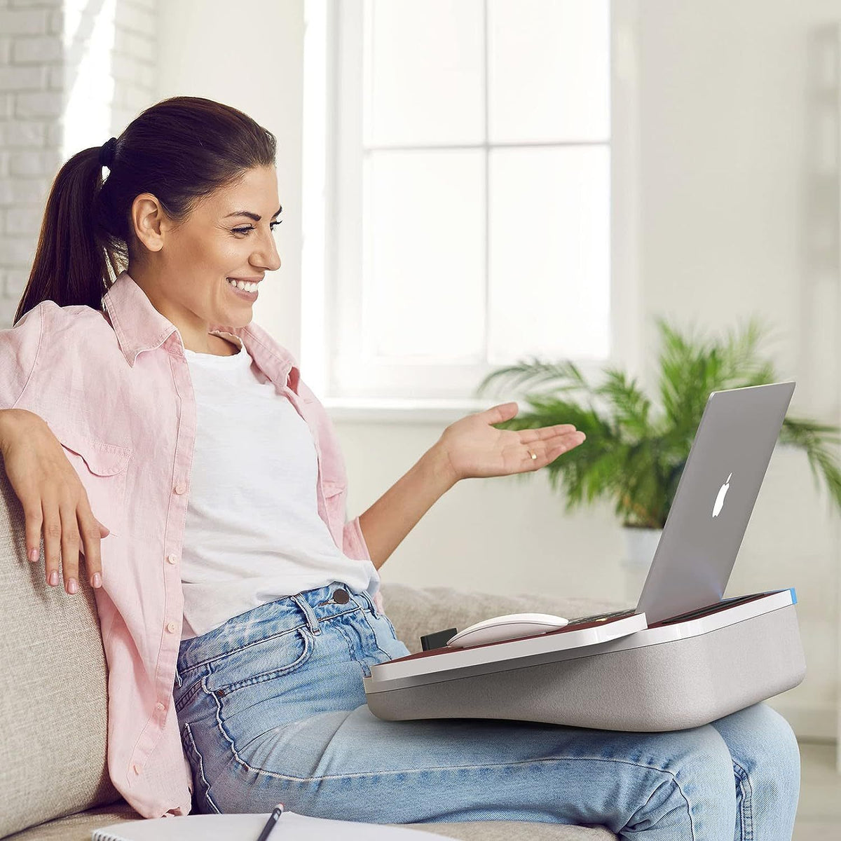 a woman sitting on a couch with a laptop