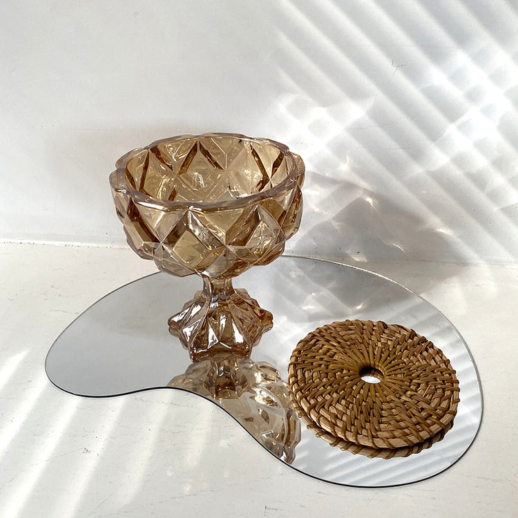 a glass bowl on a mirror