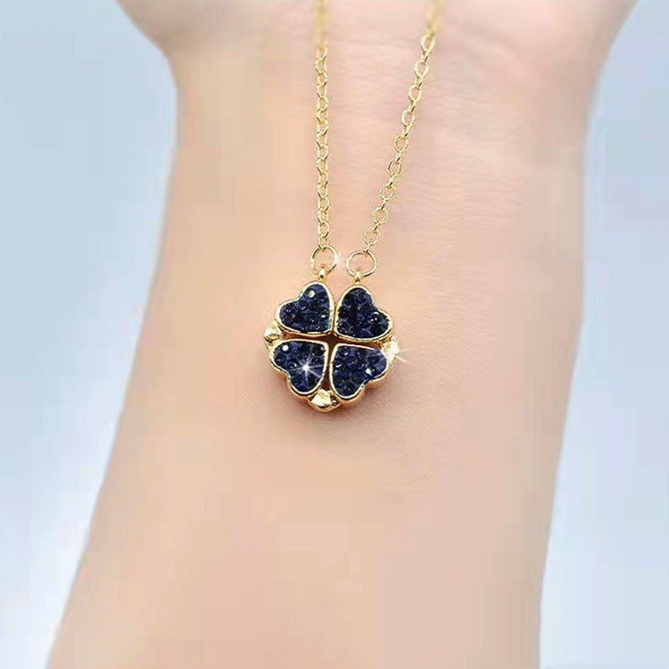 a gold necklace on a wrist