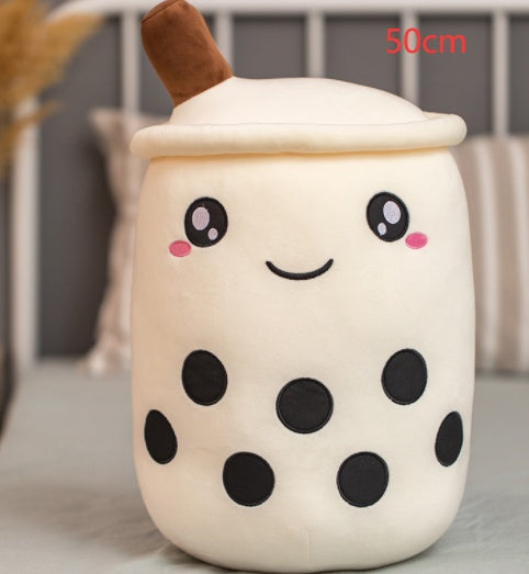 a white stuffed animal with a face and black dots