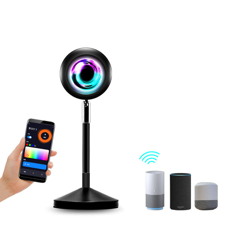 a hand holding a phone next to a round black object