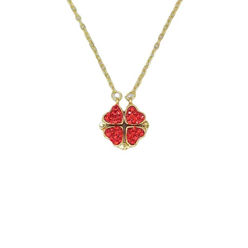 a gold chain with a red pendant