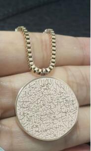 a hand holding a necklace