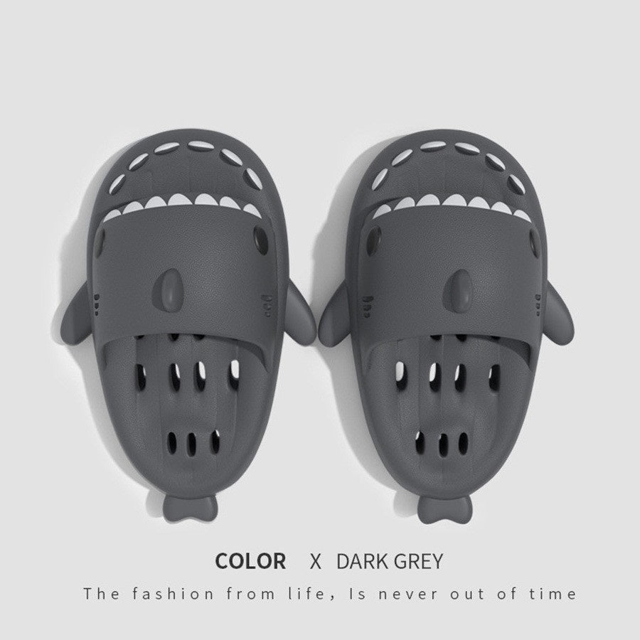 a pair of slippers with shark shaped faces