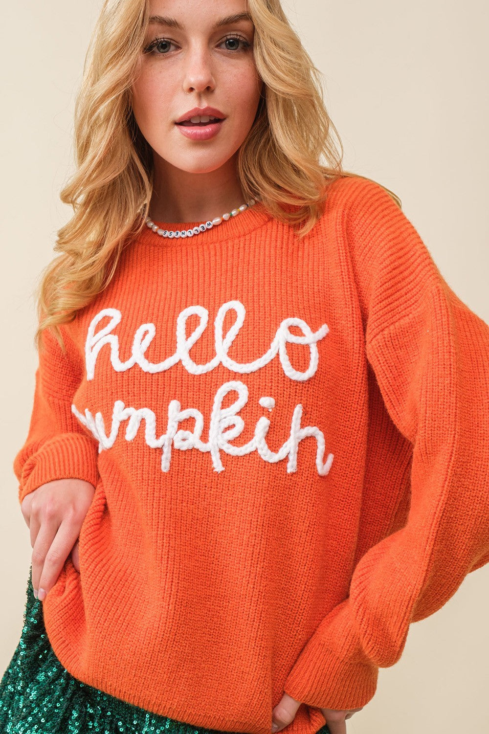 a woman in an orange sweater