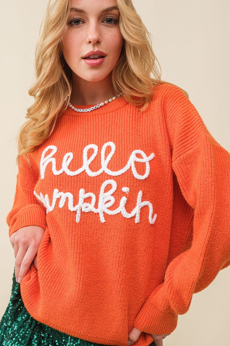 a woman in an orange sweater