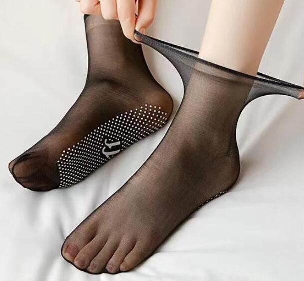 a person putting on a pair of black socks
