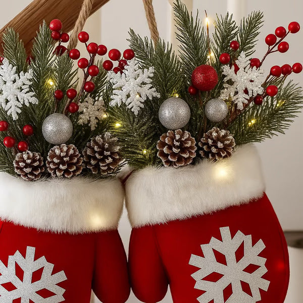 a pair of mittens with pine cones and berries