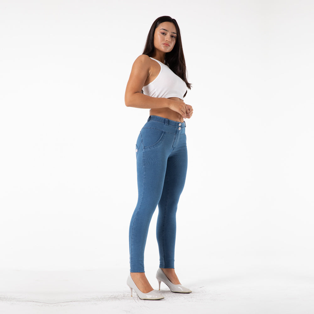a woman in a white shirt and blue jeans