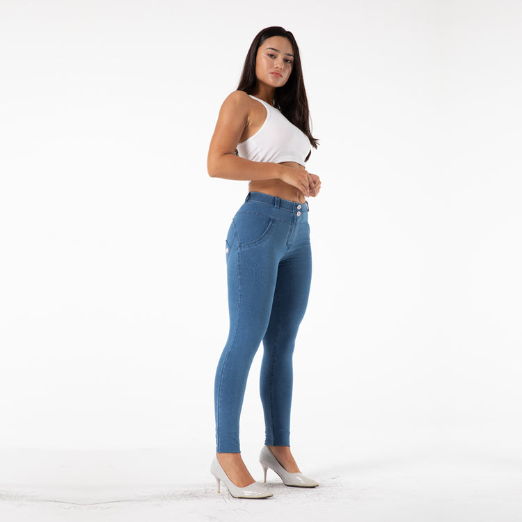 a woman in a white shirt and blue jeans