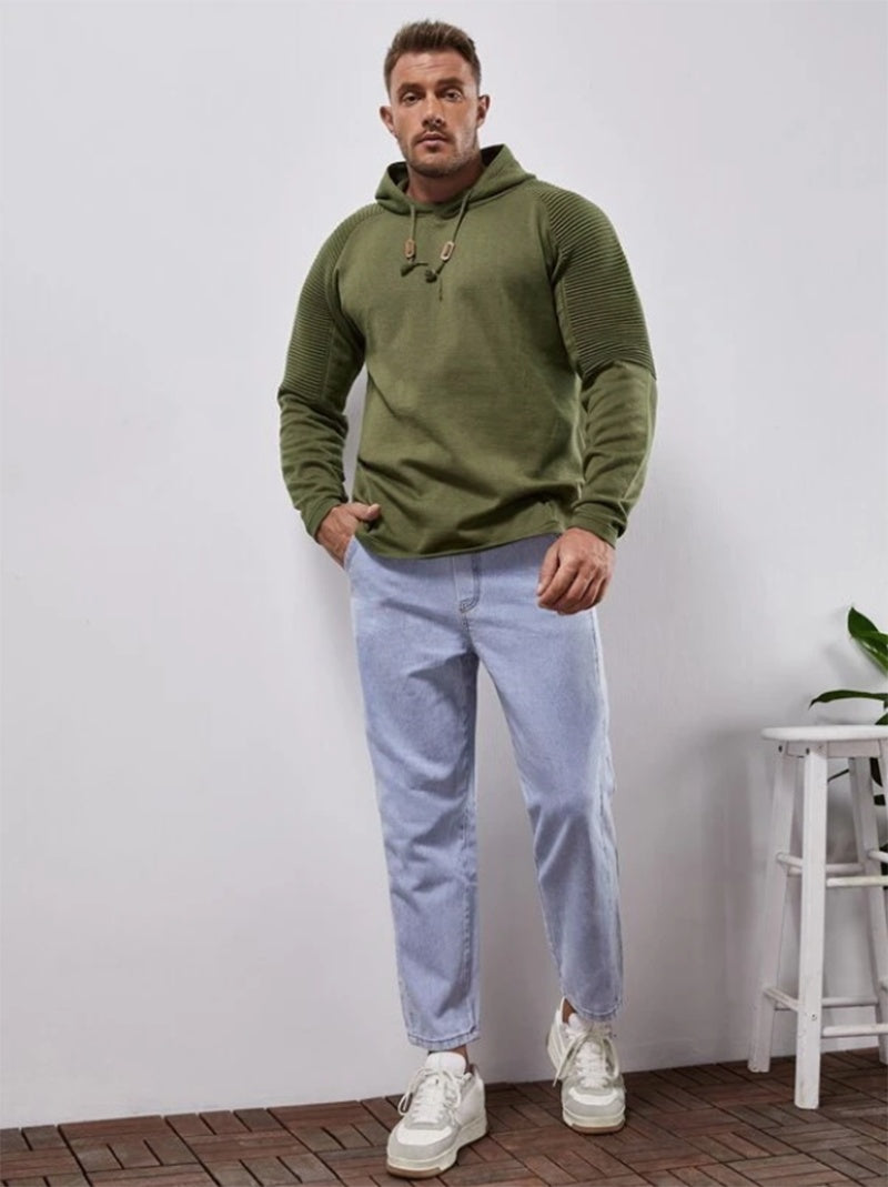a man standing in front of a white wall